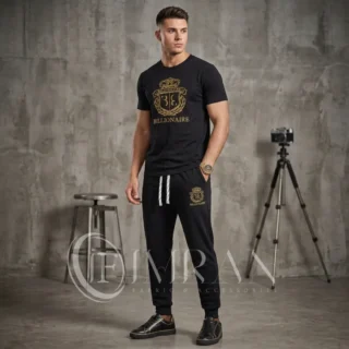 Model wearing Full 2-piece-billionaire-crest-edition-Tracksuit for men`s featuring a midnight-black"Billionaire" graphic t-shirt and onyx black joggers in photo studio