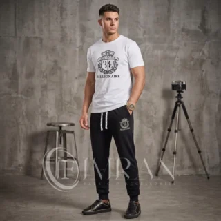 Model wearing Full 2-piece-billionaire-crest-edition-Tracksuit for men`s featuring a arctic-white-"Billionaire" graphic t-shirt and onyx black joggers in photo studio