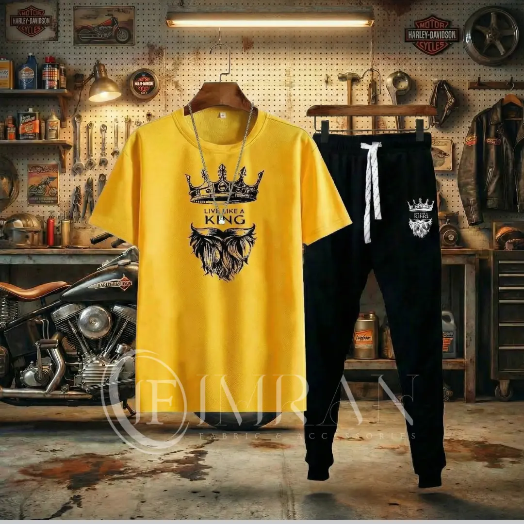 A studio product image showing sun-kissed Gold short-sleeve t-shirt with a detailed onxy black crown and beard graphic and a 'LIVE LIKE A KING' text print. hanged in busy gerage background,
