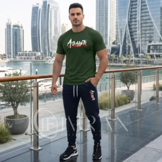 Model wearing Full 2-piece AGAINTS Urban Series Tracksuit for men`s featuring a Olive Green "AGAINTS" graphic t-shirt and onyx black joggers on th roof top of skyline buliding