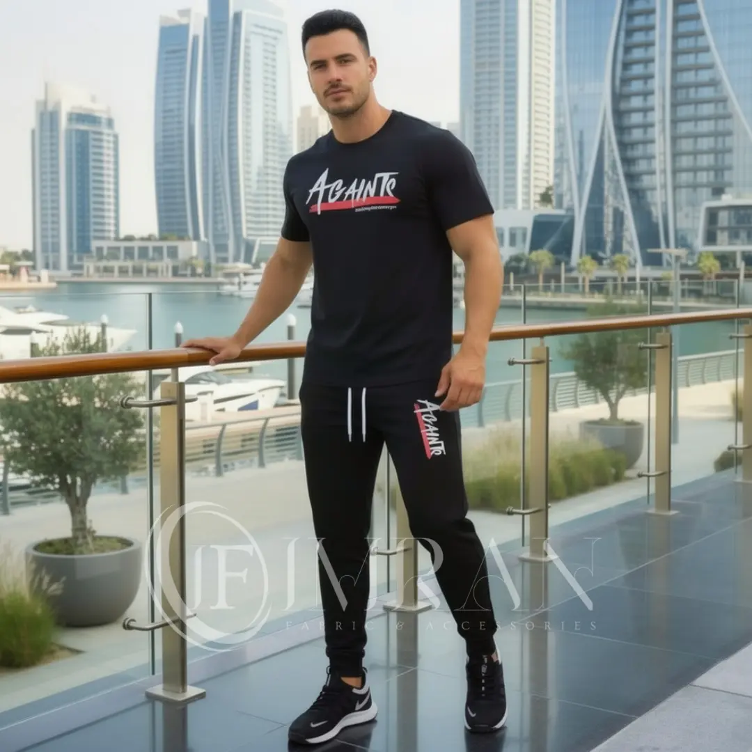 Model wearing Full 2-piece AGAINTS Urban Series Tracksuit fro men`s featuring a midnight-black"AGAINTS" graphic t-shirt and onyx black joggers on th roof top of skyline buliding